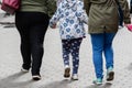 Two women and two children holding hands.  Only legs visible. Rear view Royalty Free Stock Photo