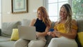 Two women using laptop and credit card at home Royalty Free Stock Photo