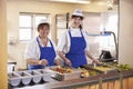 Two women waiting to serve lunch in a school cafeteria Royalty Free Stock Photo