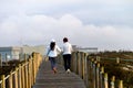 Two Women Walk on a Boardwalk Royalty Free Stock Photo