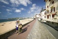 Two women walk down beach boardwalk at St. Jean de Luz, on the Cote Basque, South West France, a typical fishing village in the Fr