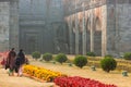 Two women walking in the misty ruins of the ancient Adina Masjid mosque in the village