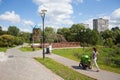 Two women walking with prams in park Royalty Free Stock Photo