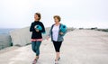 Two women walking by sea pier Royalty Free Stock Photo