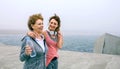 Two women walking by sea pier Royalty Free Stock Photo