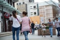 Two women walking at street of asian city.