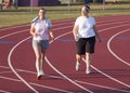 Two women walking a track Royalty Free Stock Photo