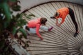 Two women warming up together and preparing for a morning run in an urban environment. Selective focus Royalty Free Stock Photo