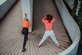 Two women warming up together and preparing for a morning run in an urban environment. Selective focus Royalty Free Stock Photo