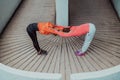 Two women warming up together and preparing for a morning run in an urban environment. Selective focus Royalty Free Stock Photo