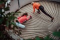 Two women warming up together and preparing for a morning run in an urban environment. Selective focus Royalty Free Stock Photo