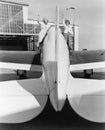 Two women waving from the wings of a plane