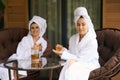 Smiling women in white robes after spa treatments Royalty Free Stock Photo