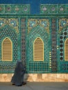 Two women wearing blue burqas walk past the Blue Mosque in Mazar i Sharif, Afghanistan Royalty Free Stock Photo
