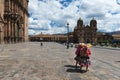 Two women wearing traditional clothes in the Plaza de Armas in the City of Cuzco, in Peru. Royalty Free Stock Photo