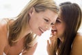 Two women whispering and smiling Royalty Free Stock Photo