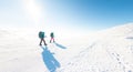 Two women on a winter hike. Girlfriends with trekking sticks go along a snow-covered mountain path. Girls with backpacks and Royalty Free Stock Photo