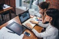 Two women working on new website design choosing pictures using the laptop surfing the internet Royalty Free Stock Photo