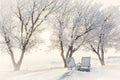 Two wood chairs sitting by fire pit covered in snow Royalty Free Stock Photo