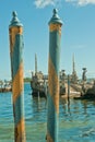 Two, wood polls, painted with blue and yellow striped, used as anchoring stations for gondolas