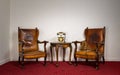 Two wooden armchairs, small coffee table and old telephone set Royalty Free Stock Photo