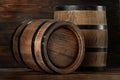 Two wooden barrels on table near wall, closeup Royalty Free Stock Photo