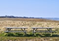 Two wooden benches on a field overlooking the ocean. A quiet place to enjoy nature and the peace it has to offer. Find