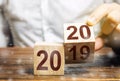 Two wooden blocks with numbers 2019 and 2020. Concept beginning of new year. New objectives. in next decade. Trends in the world.