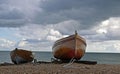 Two small boats moored by the sea along the south coast Royalty Free Stock Photo