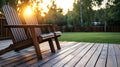 Two wooden chairs sitting on a wooden deck in a backyard Royalty Free Stock Photo