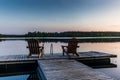 Two wooden chairs at Sunset on a pier on the shores of the calm Saimaa lakein Finland - 3 Royalty Free Stock Photo