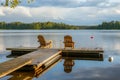 Two wooden chairs at Sunset on a pier on the shores of the calm Saimaa lakein Finland - 4 Royalty Free Stock Photo