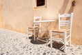 Two wooden chairs with table on the street Royalty Free Stock Photo