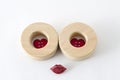 Two wooden circles with little red heart shape buttons and shinny red lips Royalty Free Stock Photo