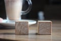 Two wooden cubes with cacao cup. Selective focus. Choise concept