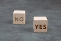 Two wooden cubes, onewith the word yes, the second one with no Royalty Free Stock Photo