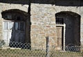 Two wooden doors, in the sun and in the shade, of a historic building in San Pellegrino in Alpe. Royalty Free Stock Photo