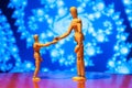 Two wooden dummy, mannequin or man figurine shake Royalty Free Stock Photo