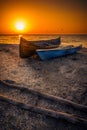Two wooden fishing boats resting on the beach at sunrise near th Royalty Free Stock Photo