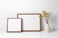 Two wooden frames mockup in white minimalistic room with copy space for artwork, photo or print Royalty Free Stock Photo