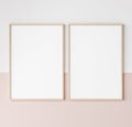 Two wooden frames on pink and white wall, frame mockup