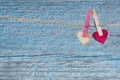 Two wooden hearts on the background of the old blue textural wooden wall.