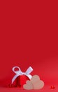 Two wooden hearts on a background of a red gift box and glass hearts on a red background. Banner Concept for Valentine's Royalty Free Stock Photo