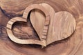 Two wooden hearts on a olive wood board Royalty Free Stock Photo