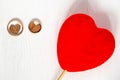 Two wooden hearts in pair wedding gold rings with red heart on white background Royalty Free Stock Photo