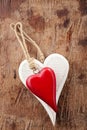 Two wooden hearts, red and white on old wood Royalty Free Stock Photo