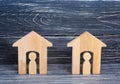 Two wooden houses with people on a black background. The concept of the district, its neighbors. Good-neighborly relations. Afford Royalty Free Stock Photo