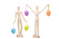 Two wooden little men with easter eggs on isolated white Royalty Free Stock Photo