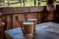 Two wooden mugs with fermented sheep milk on the table. Royalty Free Stock Photo