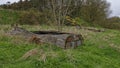 Two wooden Old and abandoned Fishing Boats or Skiffs lying upturned on the Banks of the River North Esk Royalty Free Stock Photo